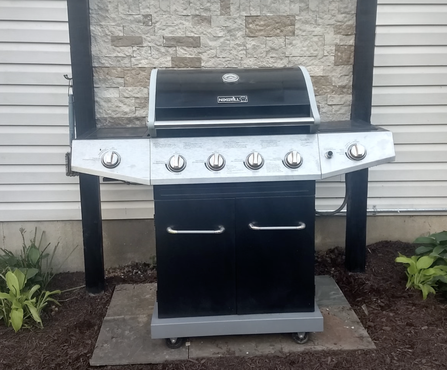 A DIY grilling station made with stone veneer.